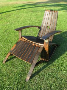 wooden adirondack chairs and ottoman made out whiskey barrels